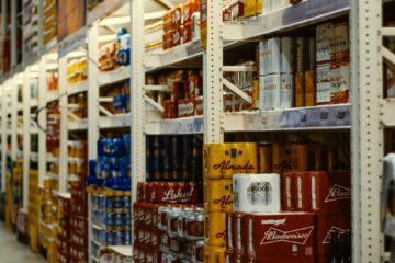 red and white labeled cans on shelf